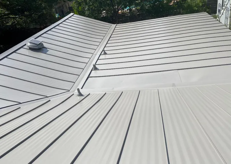 Solar attic fan installed on a metal roof for Roof Ventilation in Ashland